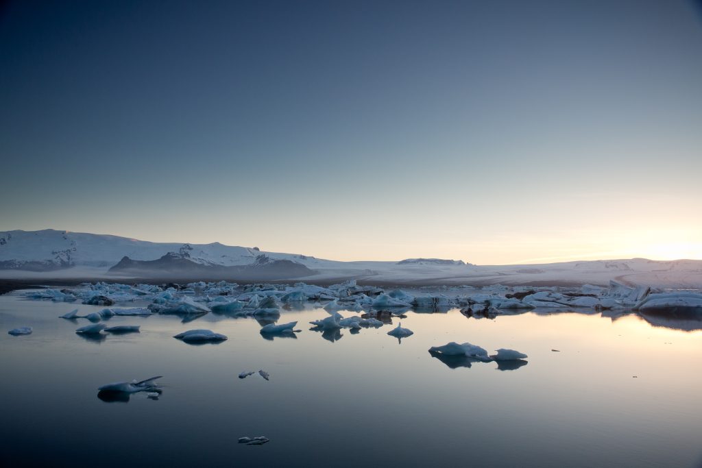 Ice floating on a glacier lagoon in Iceland with a view on a glacier.